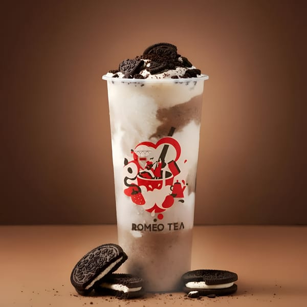Romeo Tea's Oreo milkshake with whipped cream and crushed Oreos, with two whole Oreos on the side.